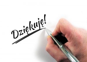 grafika przestawia rękę trzymającą długopis oraz napis: Dziękuję.