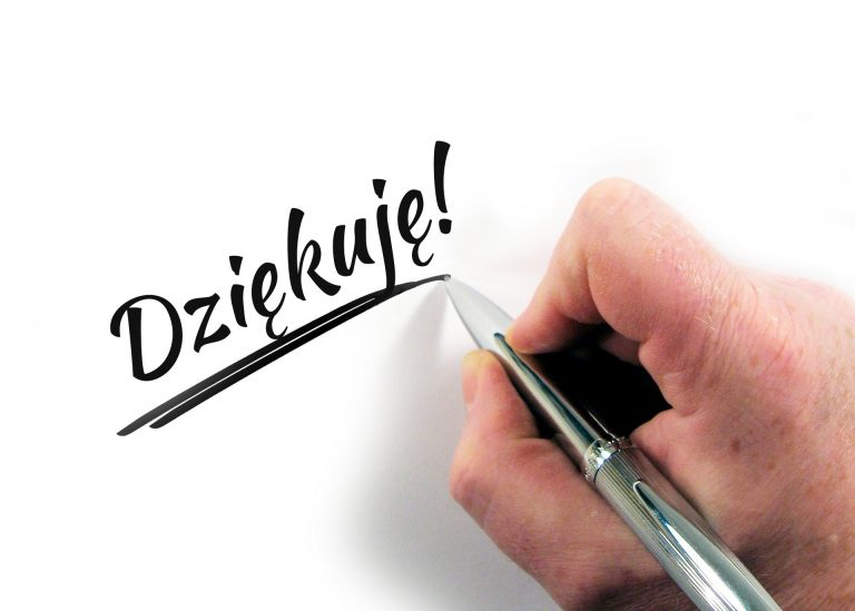 grafika przestawia rękę trzymającą długopis oraz napis: Dziękuję.